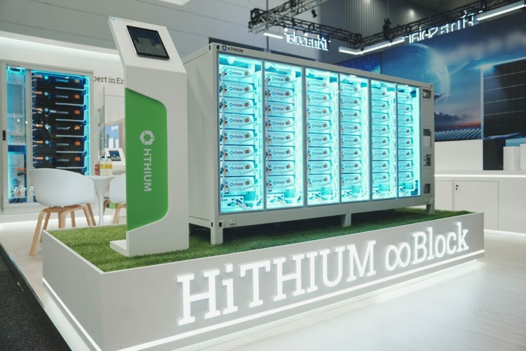 A mock-up of a Hithium containerised battery storage solution at an industry expo, with a transparent front panel to show the battery modules in place. 