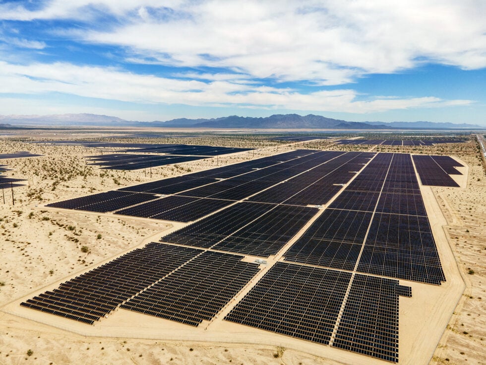 Aerial view of Intersect Power's Oberon project with grount mount solar arrays plotted against a desert landscape. 