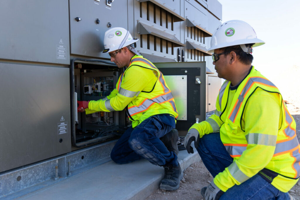 Two workers open BESS cabinets at Gemini solar-plus-storage project in Nevada, US. 