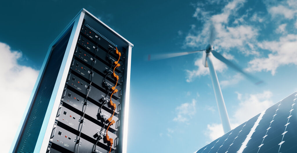 A battery storage rack filled with connected modules stands in the foreground with solar PV array and wind turbine in the background of a computer-generated image to illustrate the connected role of active cell balancing.