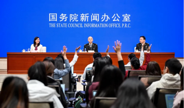 Officials behind a desk at the State Council Information Office, Peoples' Republic of China, at a press conference to announce battery export statistics. 