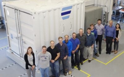 The Ambri team next to their battery, two years before the company entered Chapter 11 bankruptcy. Image: Ambri.