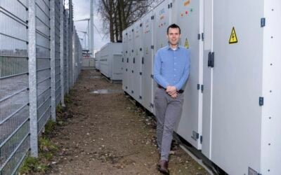 Greenchoice director of sourcing and portfolio Maurice Koenen in front of CATL enclosures at Hartel Wind Farm 2's new 20MW/40MWh BESS. Image: Greenchoice.