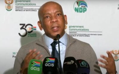 South Africa electricity and energy minister Kgosientsho Ramokgopa stands before microphones at a press conference announcing the bid window results.