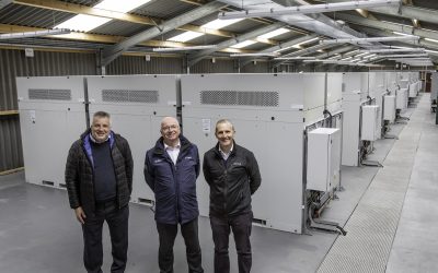 Invinity flow battery modules at the site, visited by local Member of Scottish Parliament Michael Matheson (right). Image: Invinity Energy Systems.