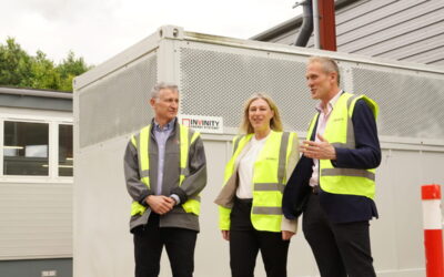 Member of Scottish Parliament (MSP) Gillian Martin (centre) standing in front of an Invinity flow battery unit at the company's Bathgate facility during a visit earlier this year. Image: Invinity Energy Systems.