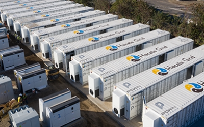A containerised battery storage project in California, branded with Hecate Grid logo.