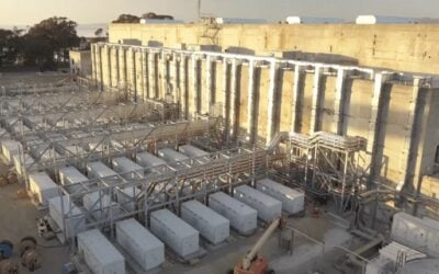 Exterior of Moss Landing Energy Storage Facility. The portion of the project which caught fire, MOSS300, was housed in the turbine hall building in the background, a design that has not been replicated anywhere else. Image: Vistra Energy