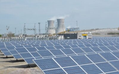 An NTPC solar PV plant with some of the power producer's thermal plant fleet in the background. Image: NTPC.