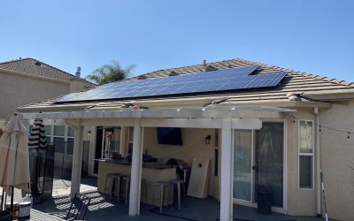 A house in the US with solar PV panels, photographed in brilliant sunshine,